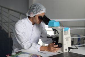 Researcher with microscope